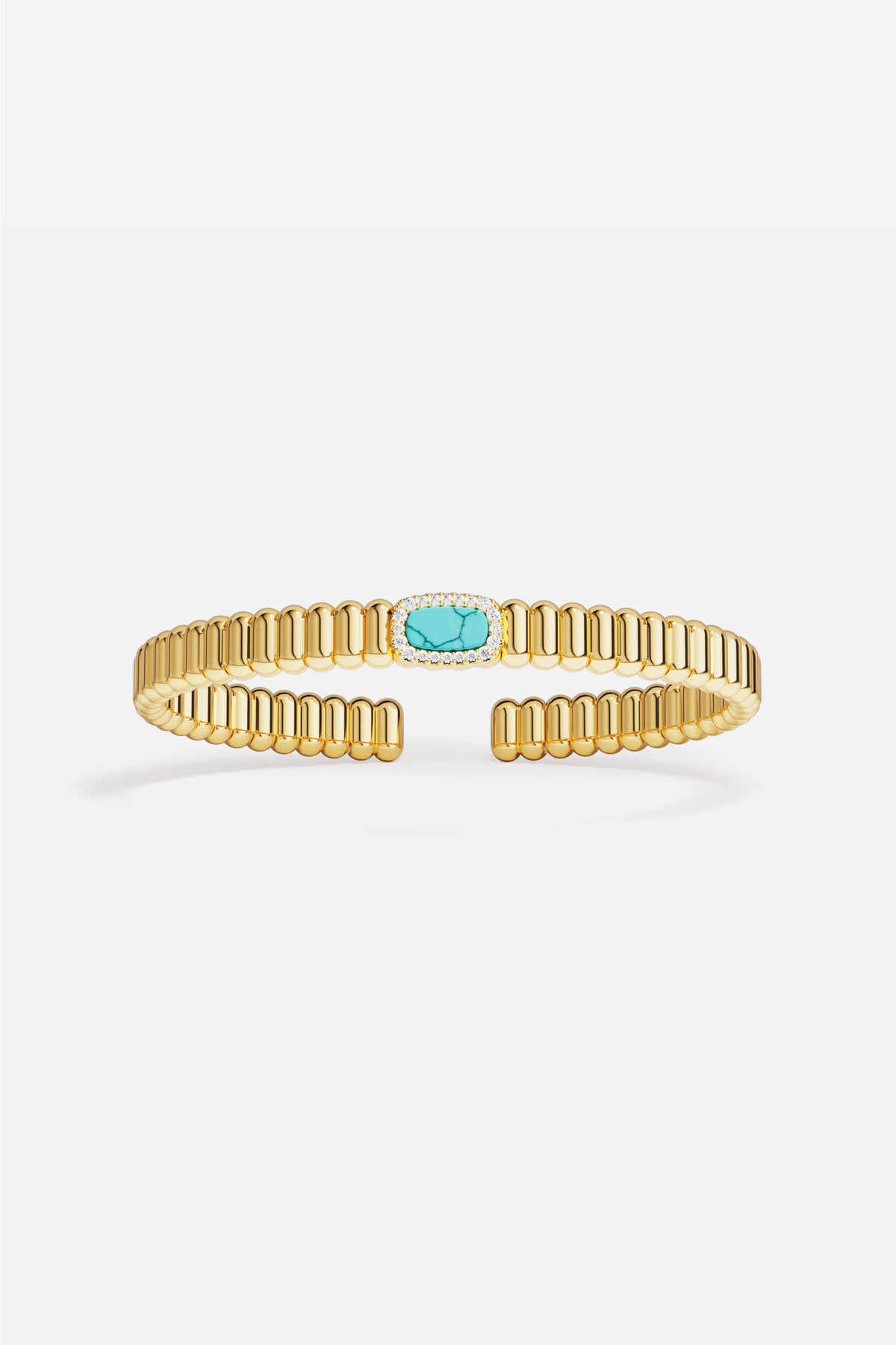 Bracelet APM doré, éclat turquoise au centre, une allure solaire et raffinée.
