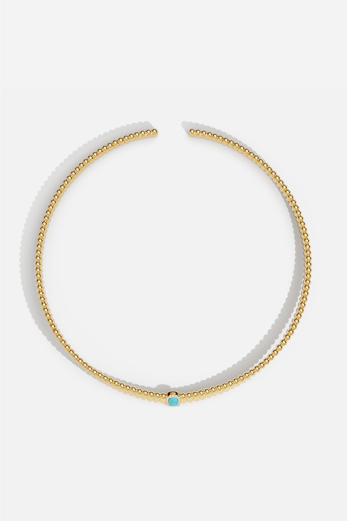 Collier APM perlé doré, touche turquoise pour une élégance solaire et délicate.