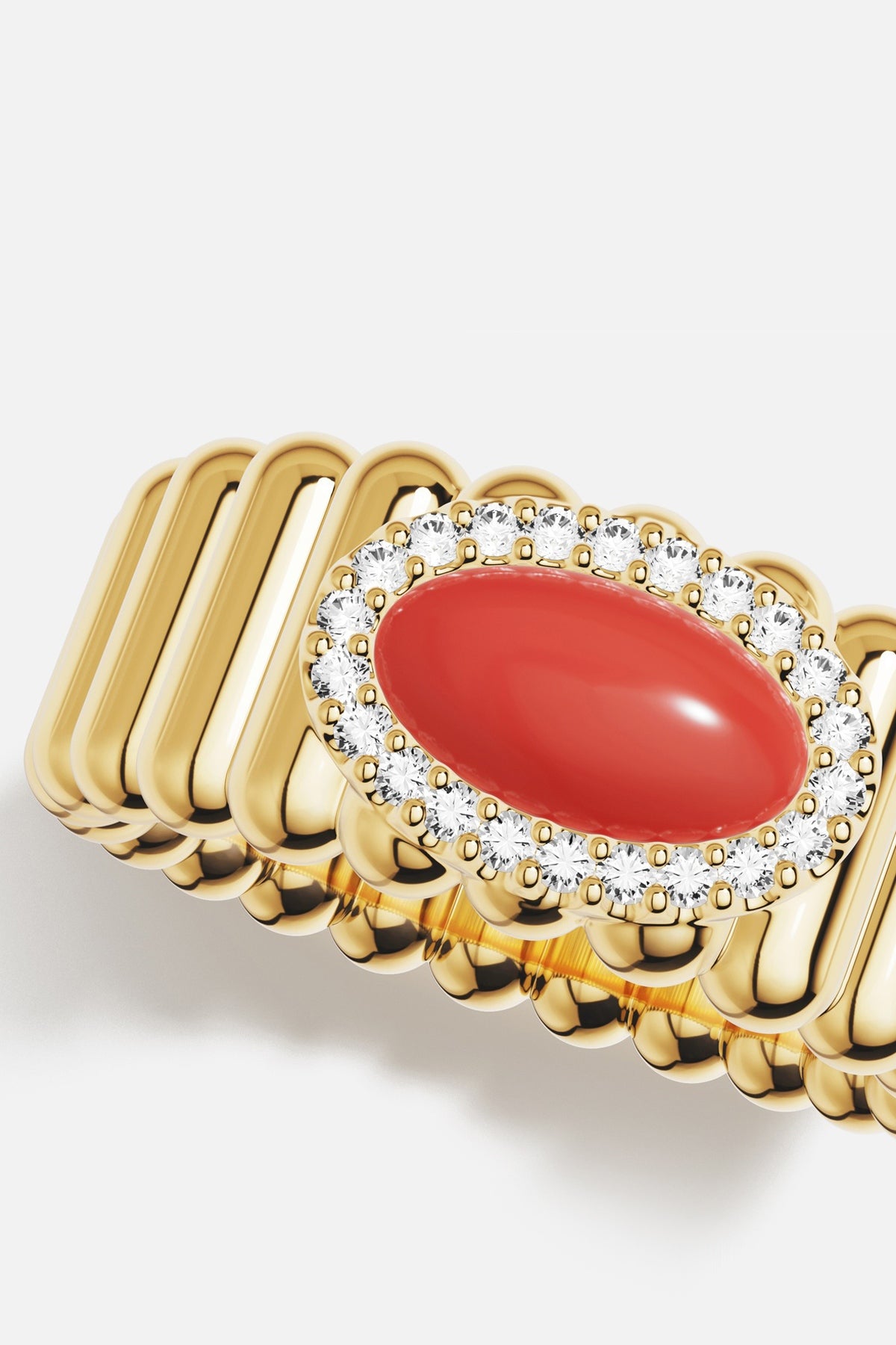 Bague APM ornée d'un cabochon corail, éclat doré et raffinement solaire.