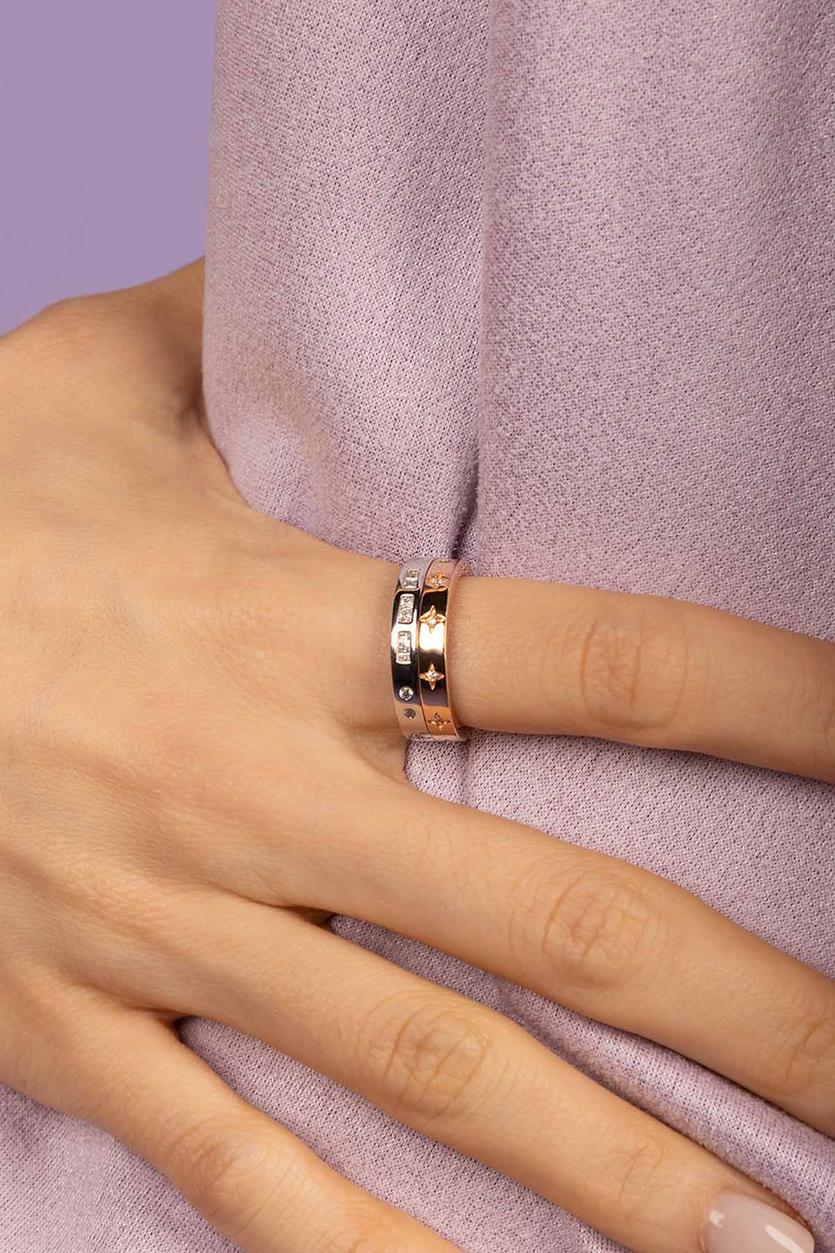 Close-up of a hand wearing a ring with a white fur background