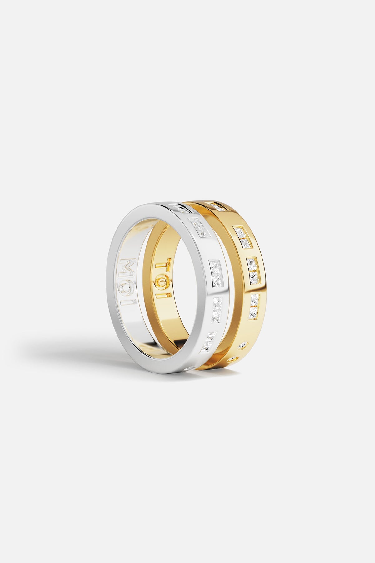 Rings APM Monaco: two stacked rings, yellow gold and white gold, white cubic zirconia, one with MOI engraving.