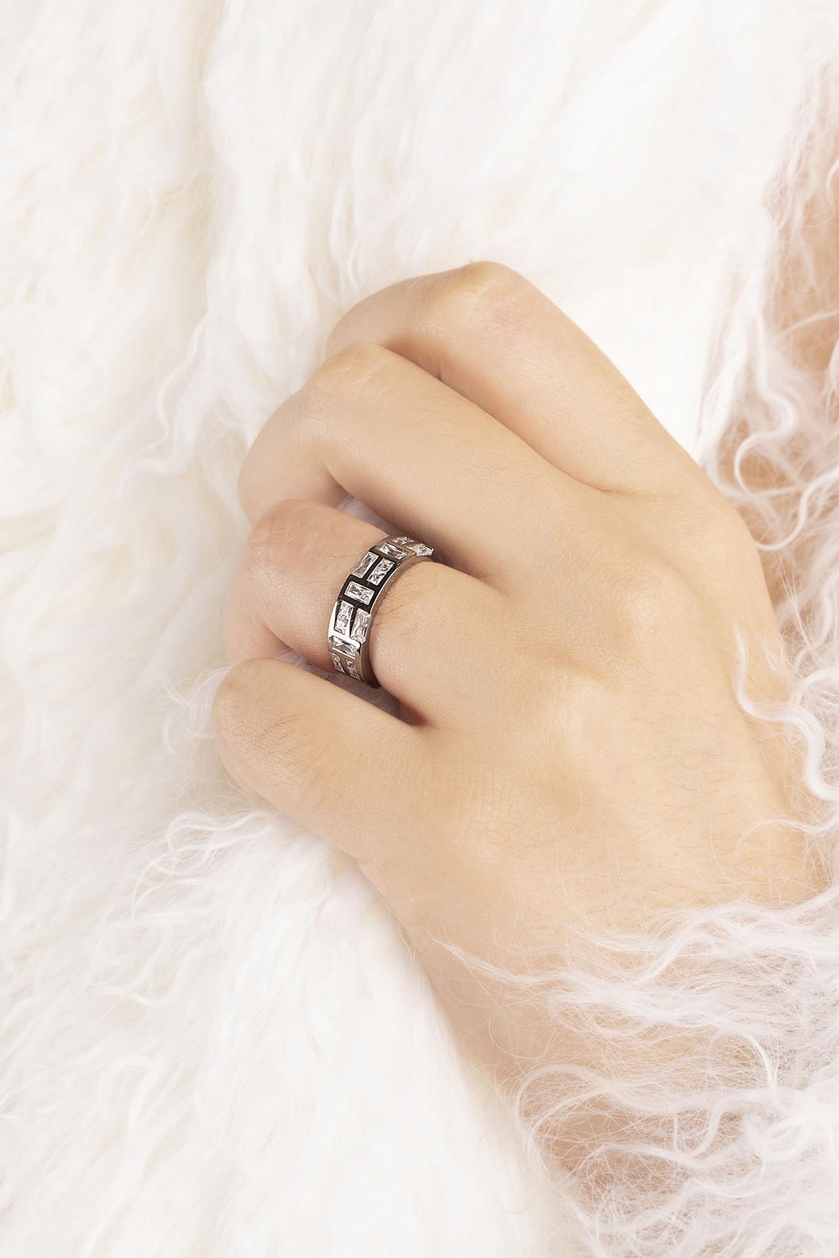 Hand wearing a silver APM MONACO ring
on a white background