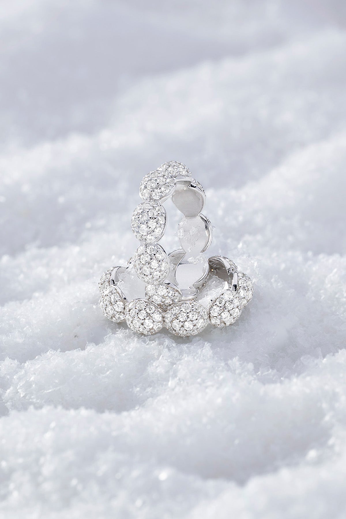 APM MONACO pave ring in silver on a clear snowy background