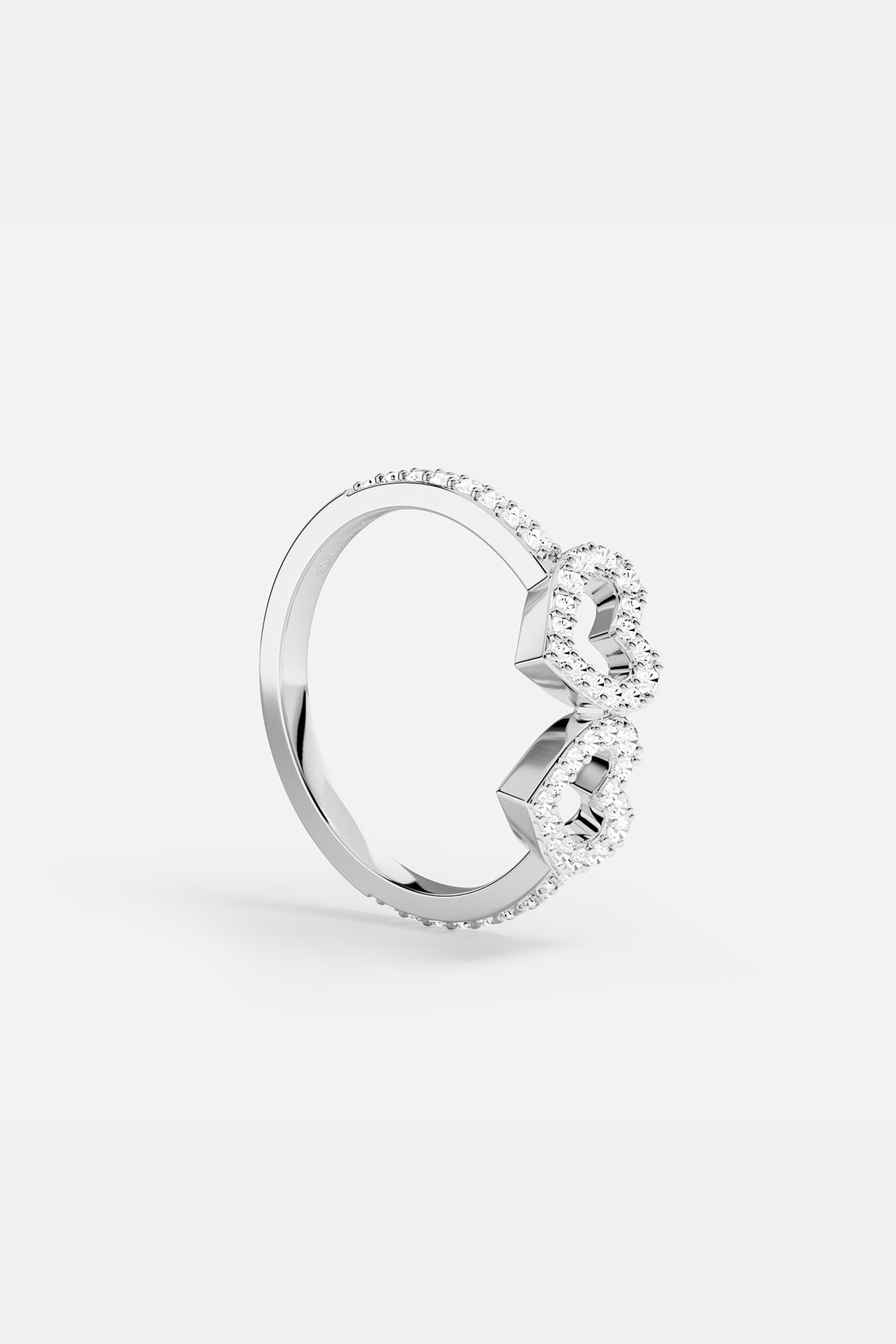 APM MONACO silver ring with two heart-shaped designs on a white background