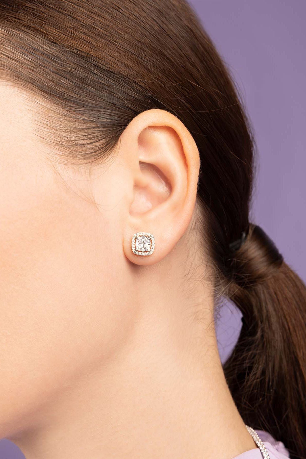 Earrings APM Monaco: square stud earrings with white stones set in silver-tone metal encasing.