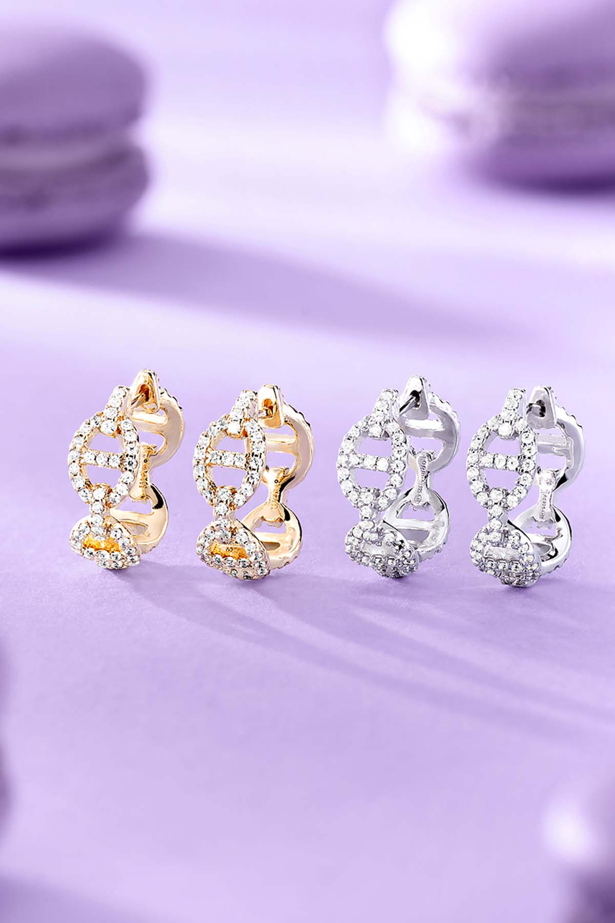 Woman wearing a green cap and brown jacket with jewelry against a cactus background