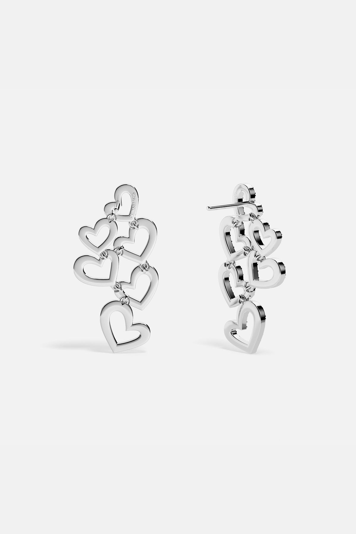 APM MONACO heart-shaped earrings in silver on a white background