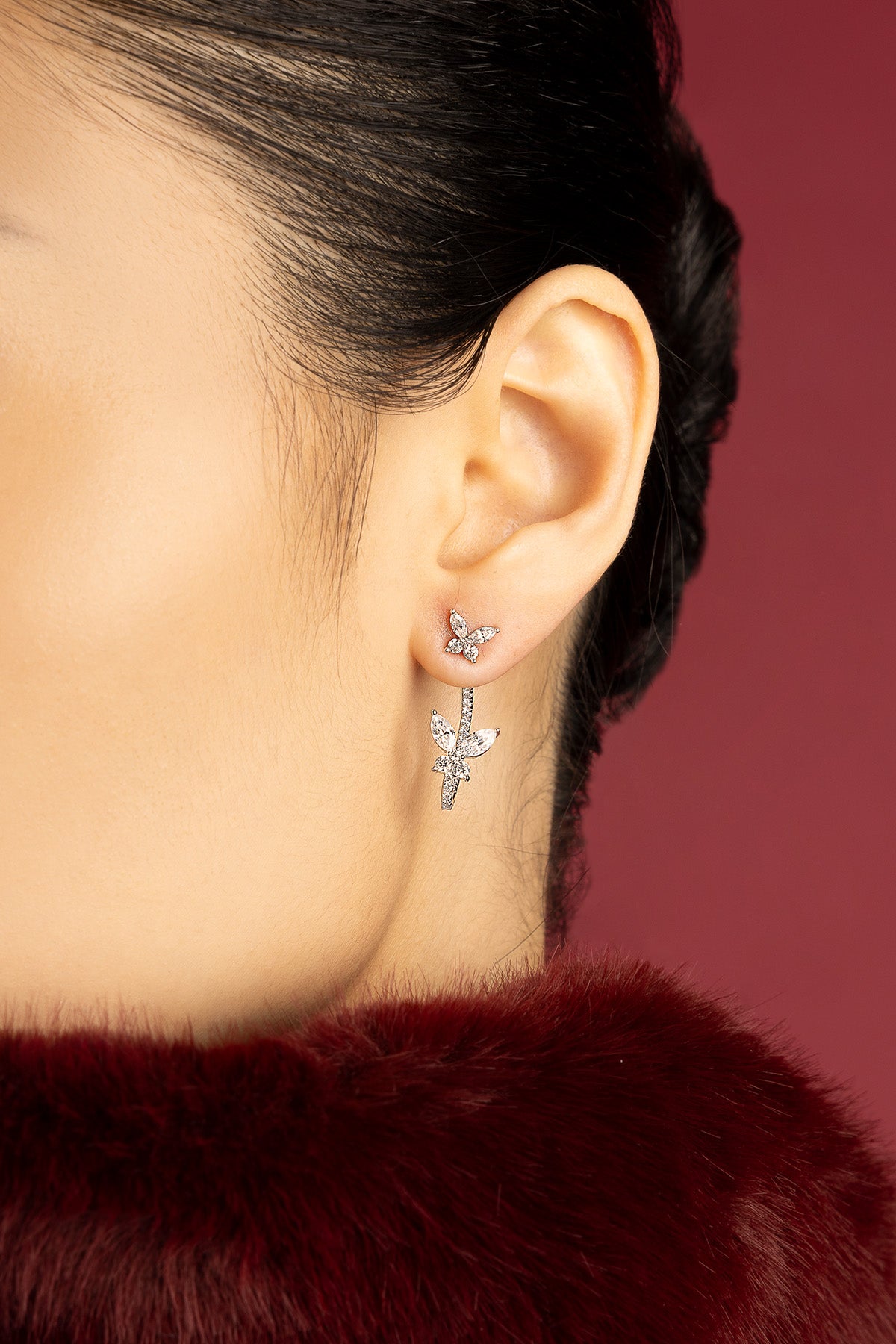 Femme portant les boucles d'oreilles papillons APM Monaco, une envolée délicate et lumineuse.