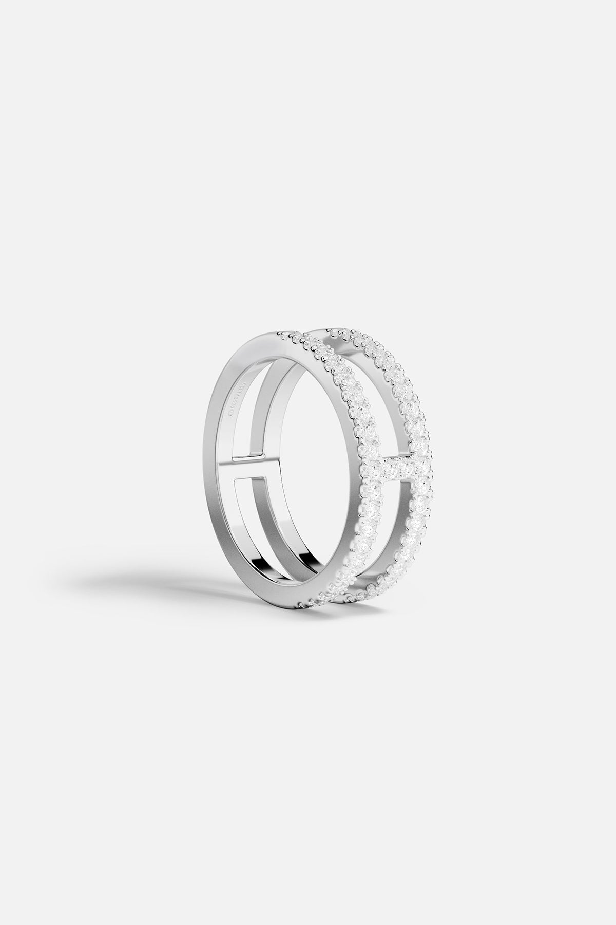 Rings APM Monaco: silver-toned ring with double pavé rows of small clear stones and two horizontal bars.