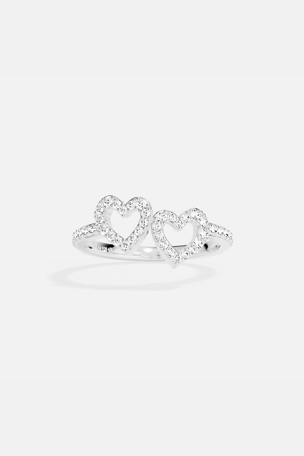 APM MONACO silver ring with two heart-shaped designs on a white background
