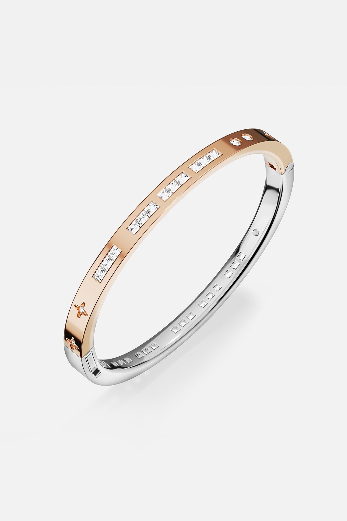 Bracelets APM Monaco two-tone gold and silver bangle with inlaid white stones.