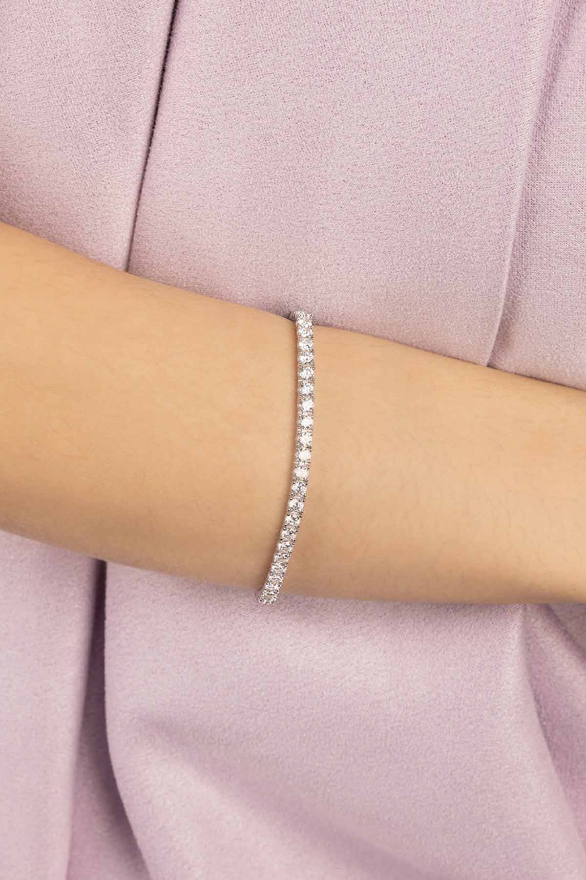 APM MONACO silver tennis bracelet on a person's wrist with a white background