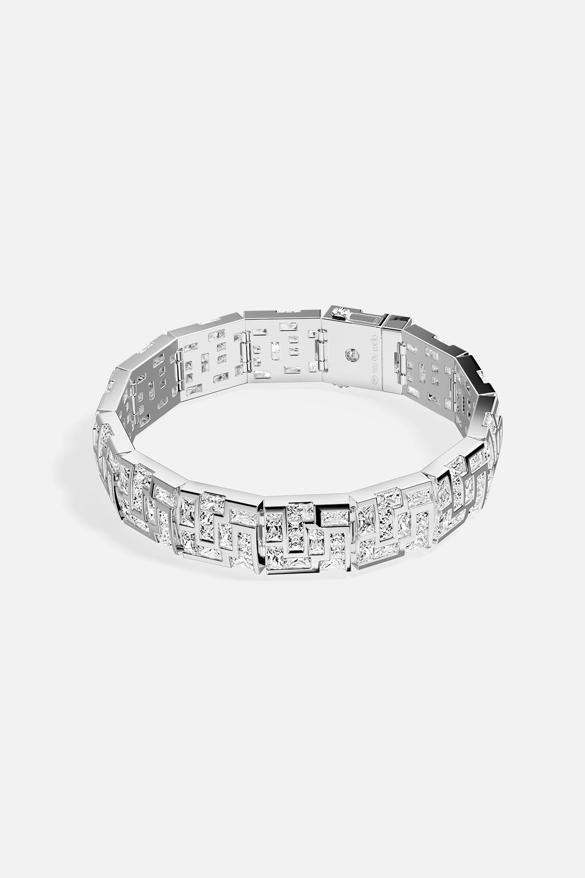 APM MONACO chunky labyrinth bracelet in silver with rectangular stones on a light gray background