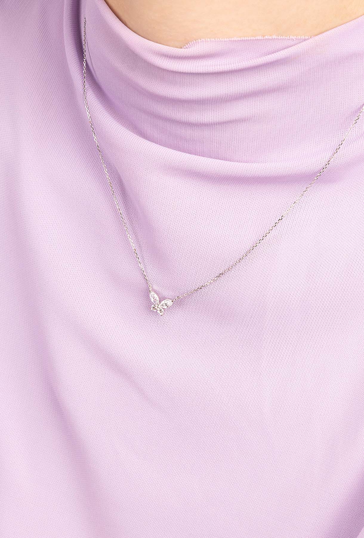 APM MONACO butterfly necklace in silver worn on model