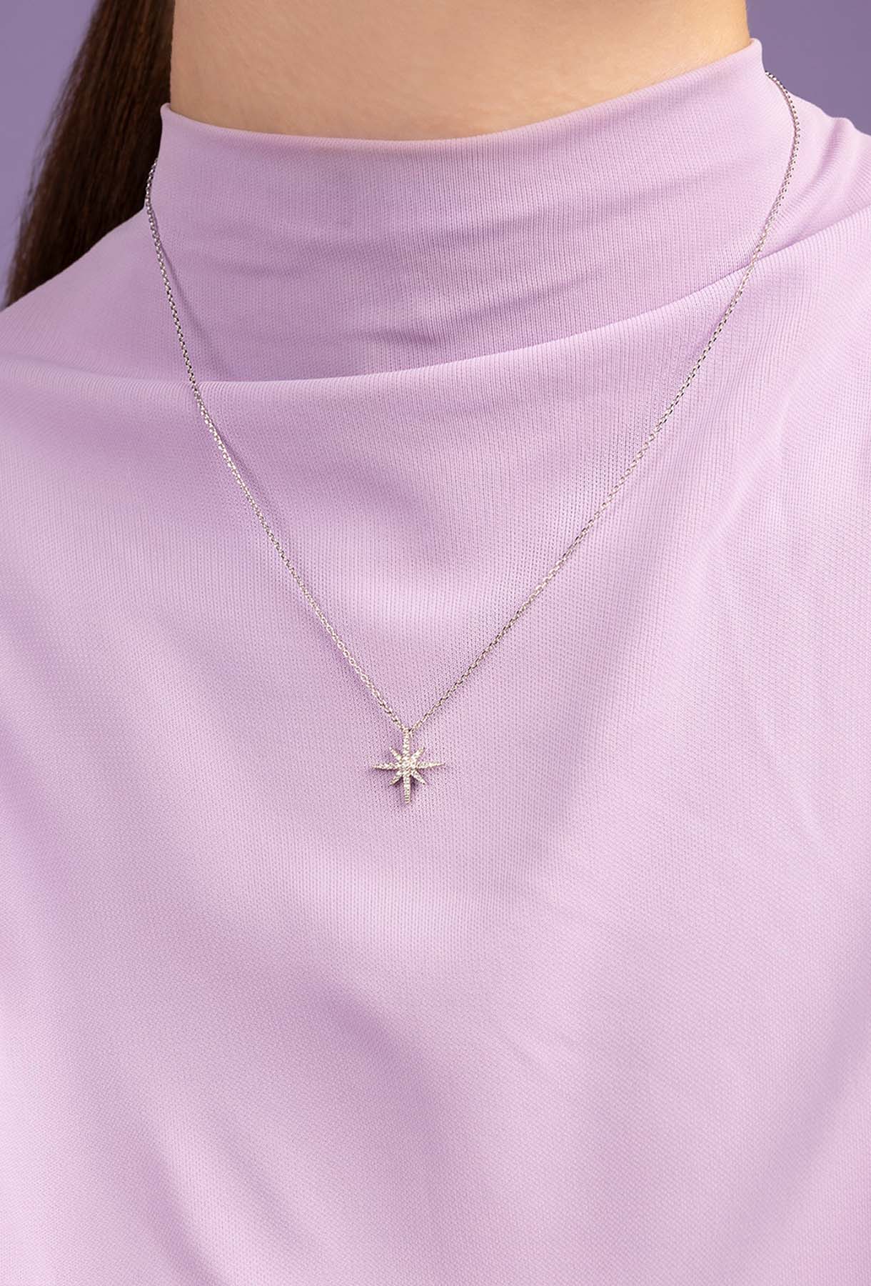 Star-shaped necklace on a model with a light background