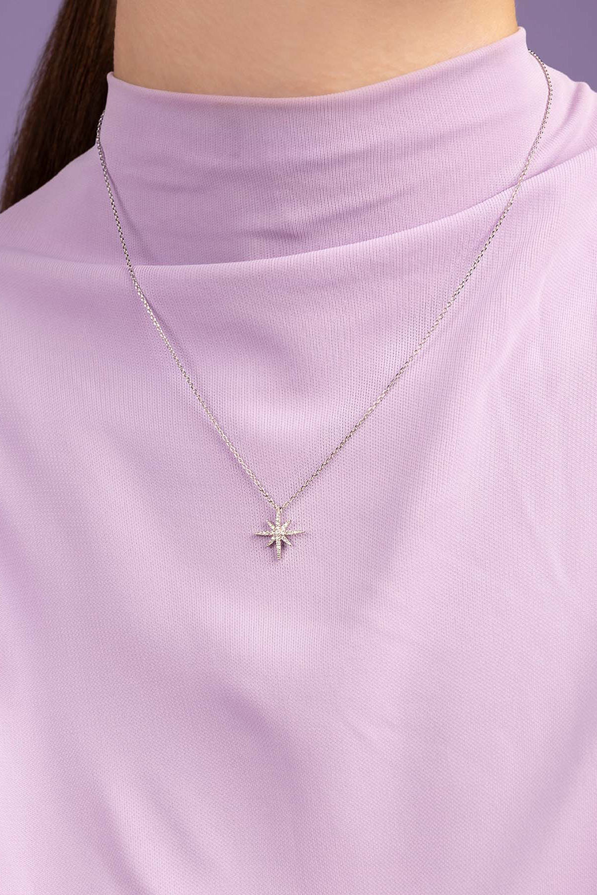 Necklaces APM Monaco, silver star-shaped pendant on a chain with meteorite texture.