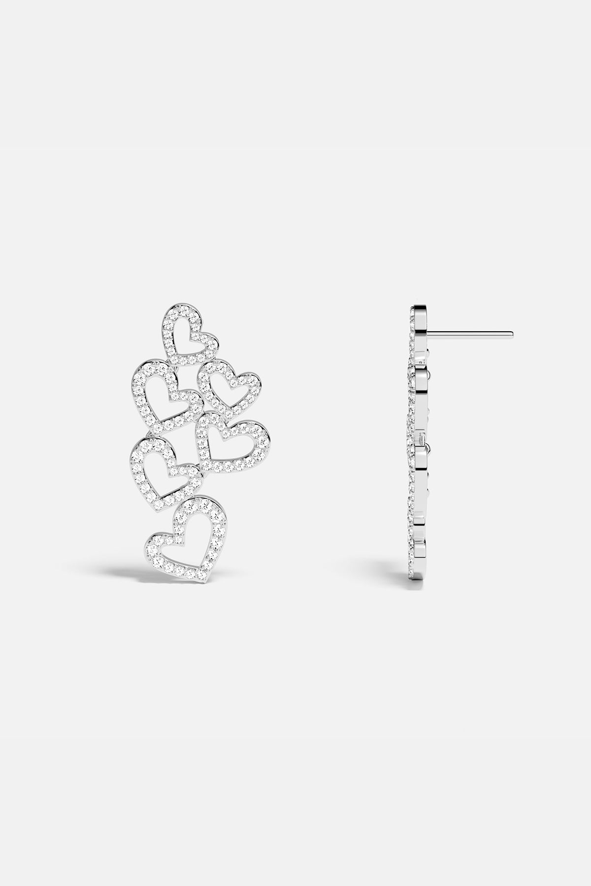 APM MONACO heart-shaped earrings in silver on a white background