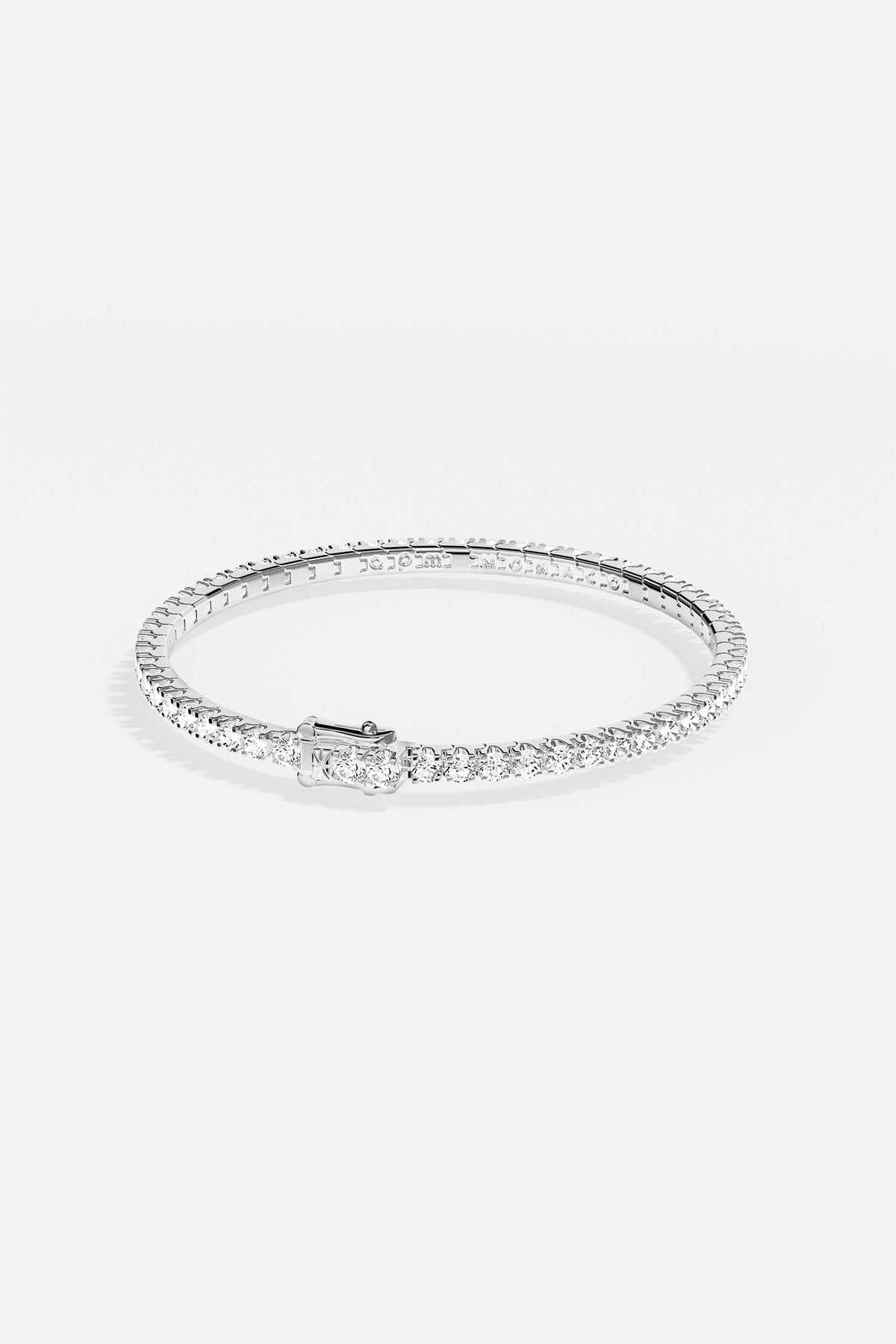 Bracelets APM Monaco pavé white stones on a silver-tone bracelet.