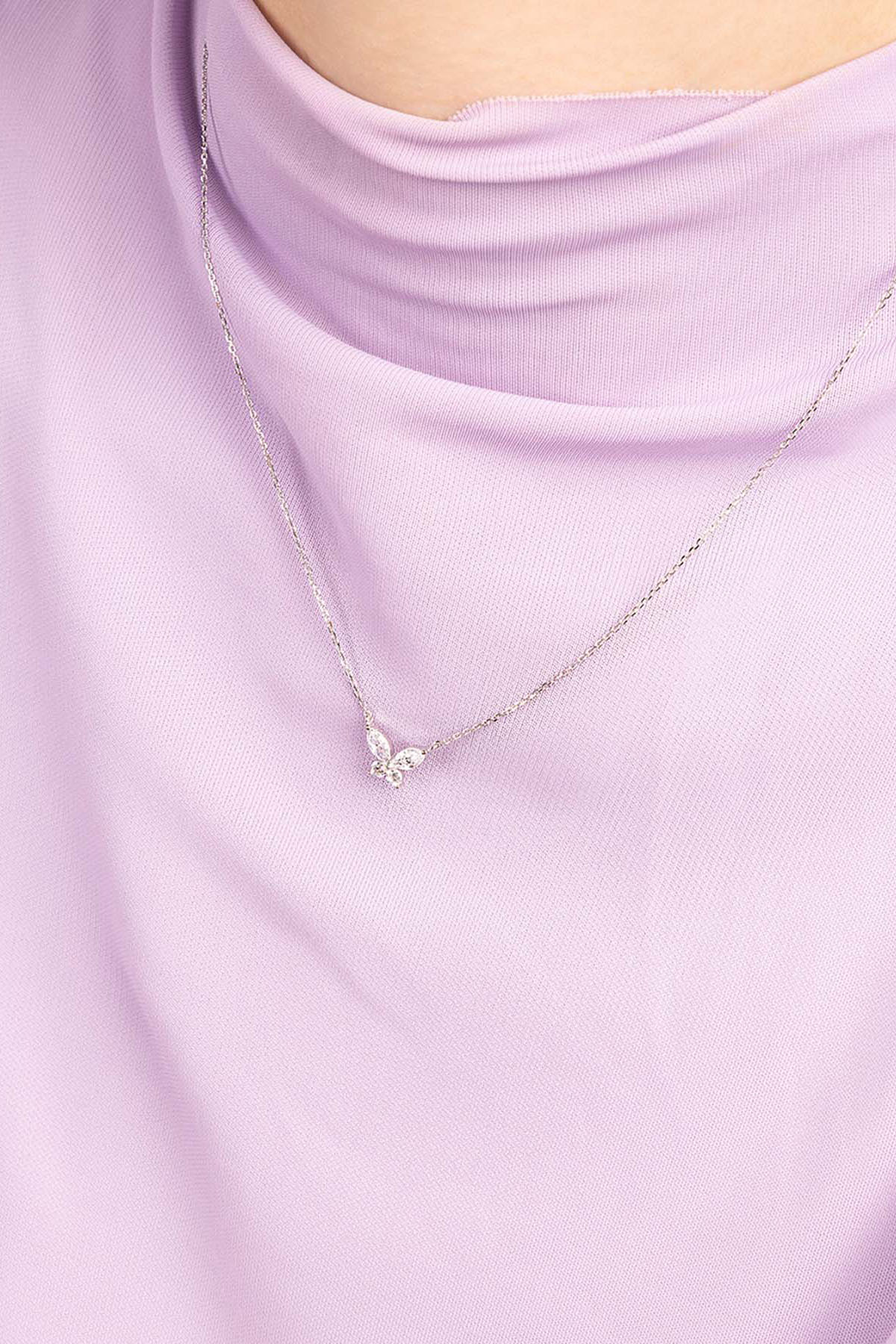 APM MONACO butterfly necklace on purple top