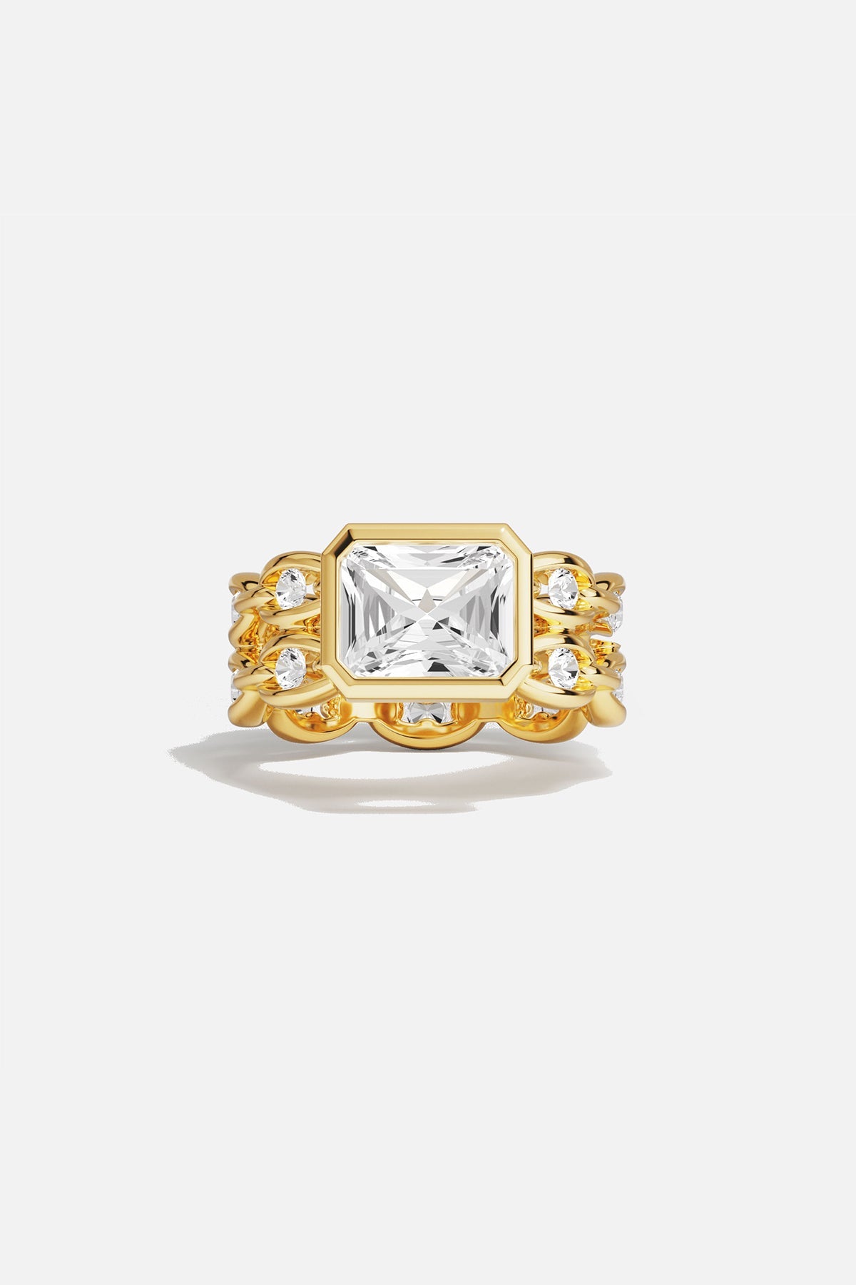 Rings APM Monaco yellow gold statement ring with a large square-cut white center stone surrounded by a pavé halo of smaller stones.
