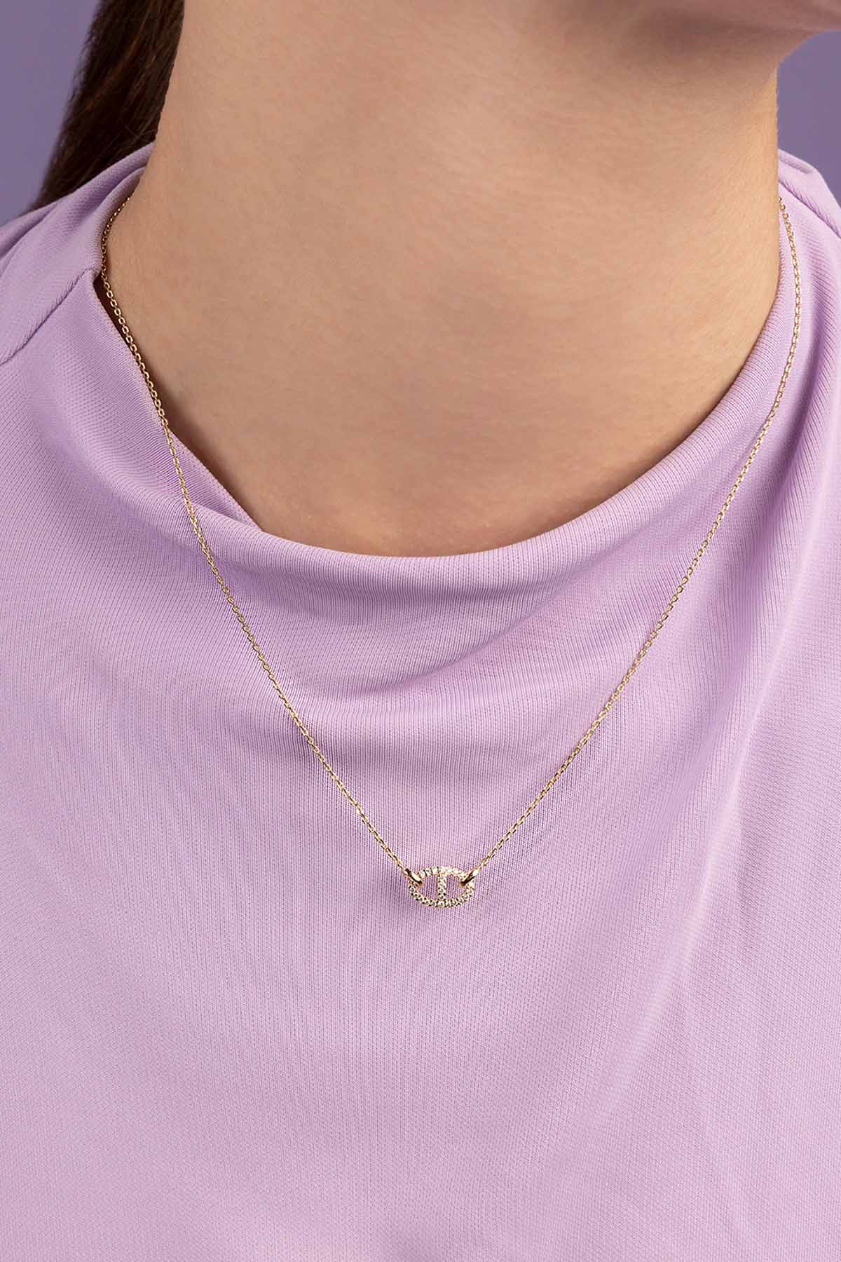 Necklace with a small pendant worn by a person